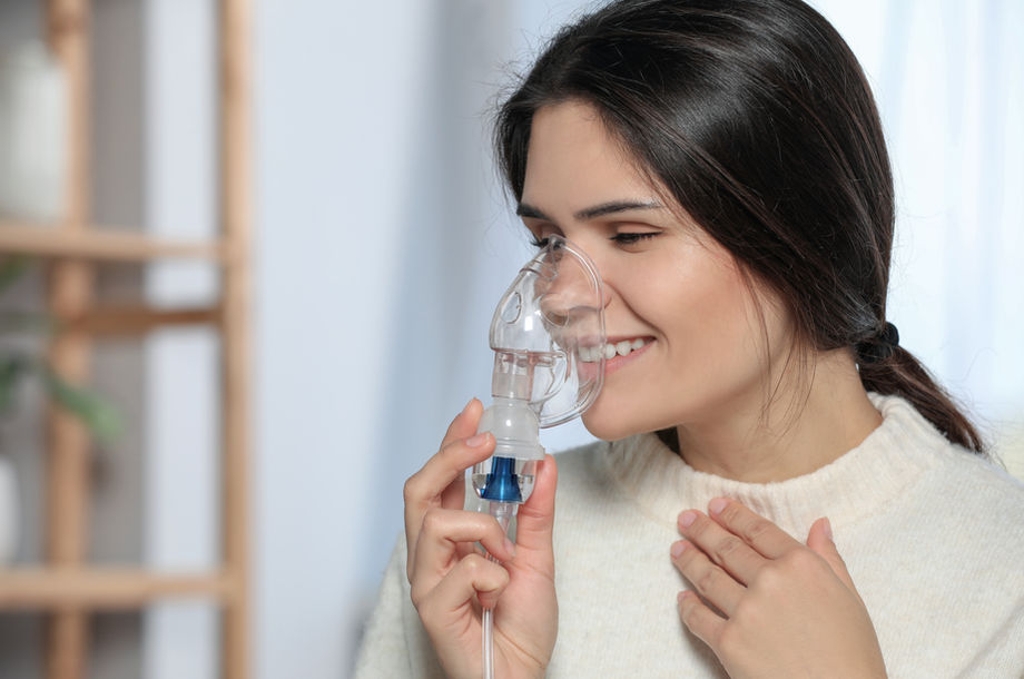 Woman using a nebulizer at home